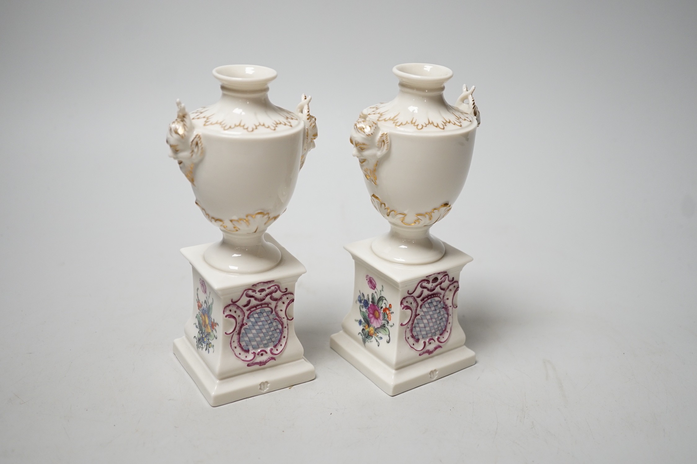 A pair of Nymphenburg urns, marked to base. 15.5cm tall
